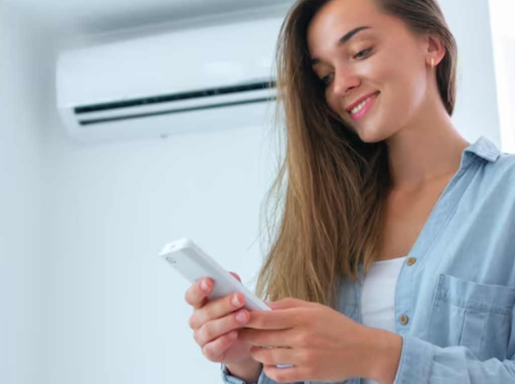 mulher-segura-controle-ar-condicionado