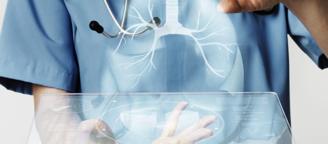 Doctors using transparent tablet with hologram medical technology