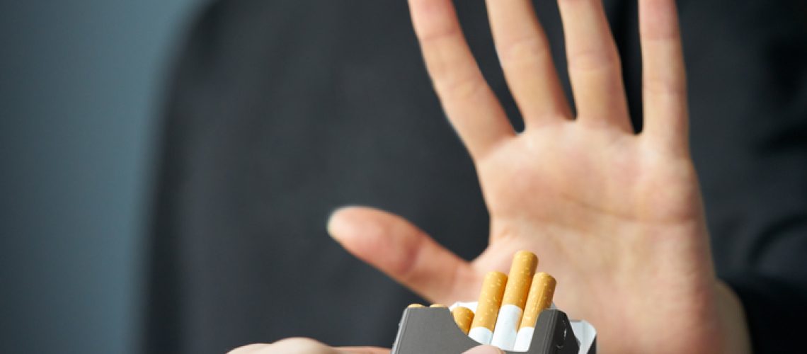 Quitting smoking concept. Hand is refusing cigarette offer